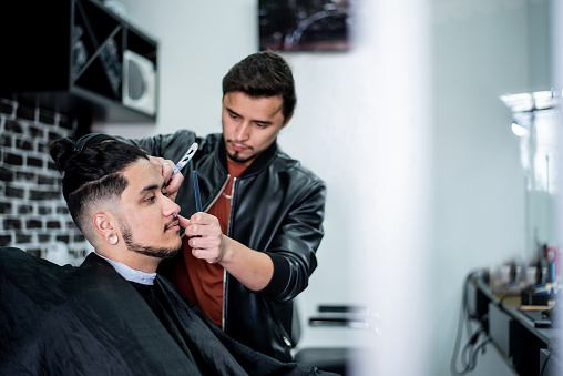 Barber shaving a trans man