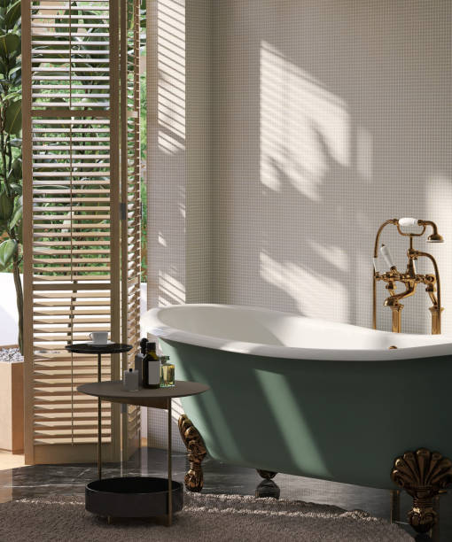Dark brown side table by green cast iron claw feet bathtub in luxury design bathroom and tropical tree with sunlight from window blinds and leaf shadow on white mosaic wall Dark brown side table by green cast iron claw feet bathtub in luxury design bathroom and tropical tree with sunlight from window blinds and leaf shadow on white mosaic wall for personal care and toiletries product display free standing bath stock pictures, royalty-free photos & images