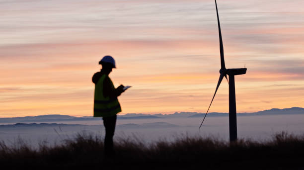 Female wind energy engineer working in wind farm. Renewable Energy Systems. Carbon neutrality and sustainable energy. stock photo