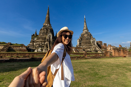 Couple of Asian tourist come to visit at Wat Phra Si Sanphet temple, Ayutthaya Thailand, for travel, vacation, holiday, honeymoon and tourism