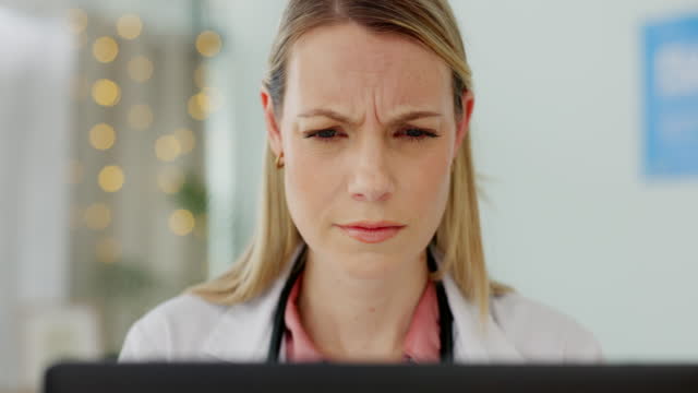 Doctor, laptop and confused woman in office reading mistake on patient records or results. Computer glitch, pc error and female doctor in hospital worried about medical diagnosis or report with bokeh