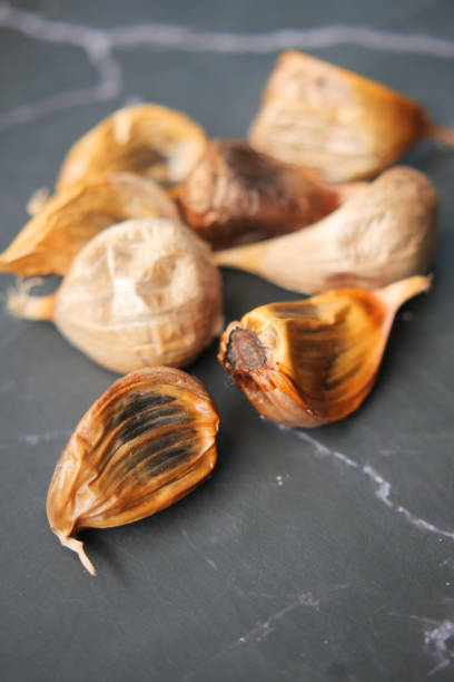 istock close up pf black garlic on white background table 1441544136