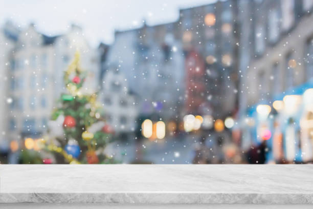 istock Empty white marble table top on blur with bokeh Christmas tree and new's year decoration on window banner background with snowfall - can be used for display or montage your products. 1441544818