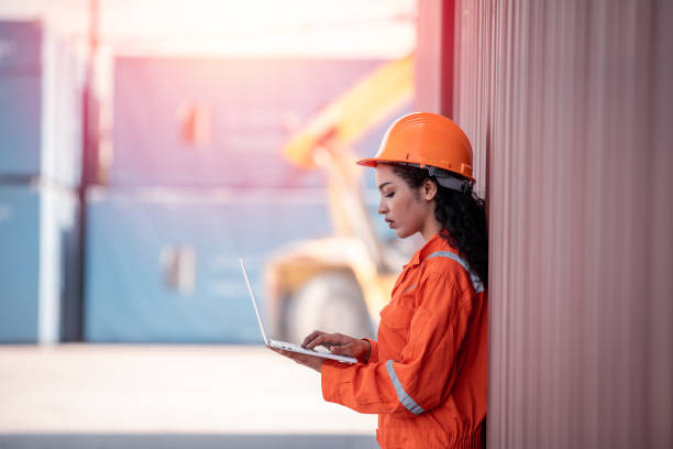 istock Portrait Engineer worker under working inspection and checking with radio communication ,file ducument container dock yard shipping dock yard logistics export import business concept. 1441545268