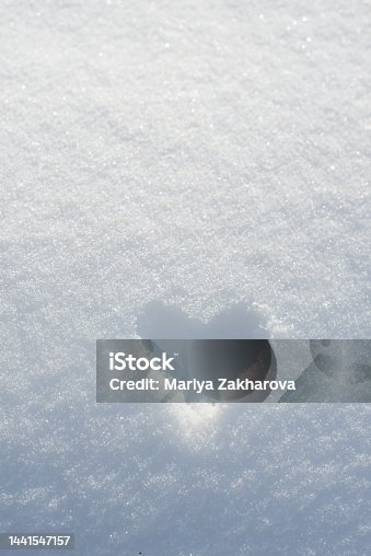 istock Heart shape painted on white snow background. Frozen heart, snow Valentine, Valentine days postcard background with  copy space 1441547157