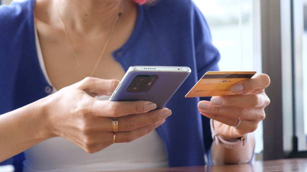 istock Woman's hand use smartphone for mobile banking 1441548698