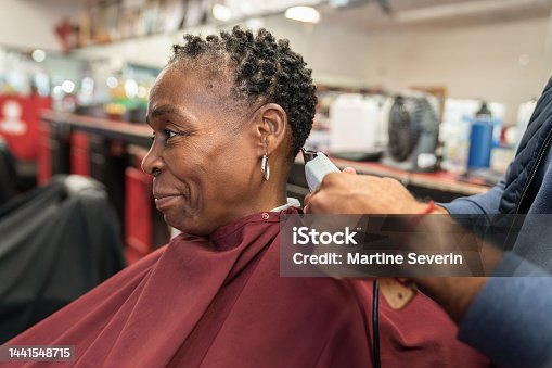 istock Black customers receive a haircut from barbers at a Black owned Barbershop 1441548715
