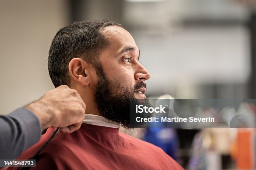 istock Black customers receive a haircut from barbers at a Black owned Barbershop 1441548793