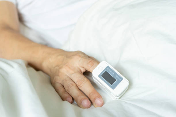 istock View of male patient using oximeter on finger lying in bed. 1441551653