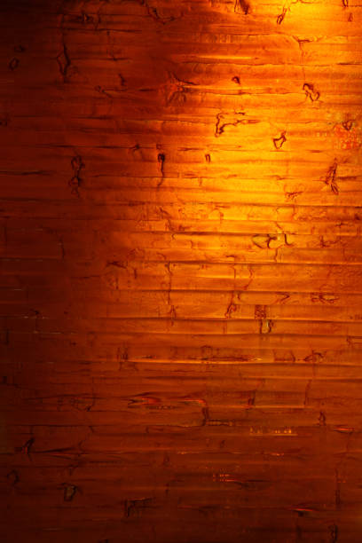 The brown-orange brick wall has a yellow glow through it