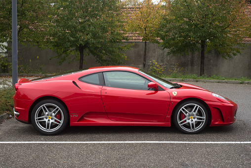 Mulhouse - France - 13 November 2022 - Profile view of red ferrari F430 parked in the street