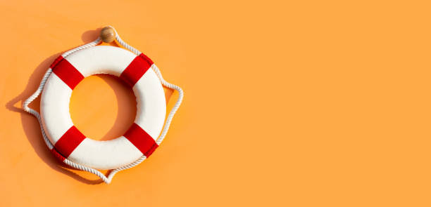 istock Lifebuoy on orange background. Copy space 1441558252