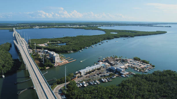 The Florida Keys - Key Largo bridge drone view at sunset The Florida Keys - Key Largo bridge drone view at sunset key largo stock pictures, royalty-free photos & images