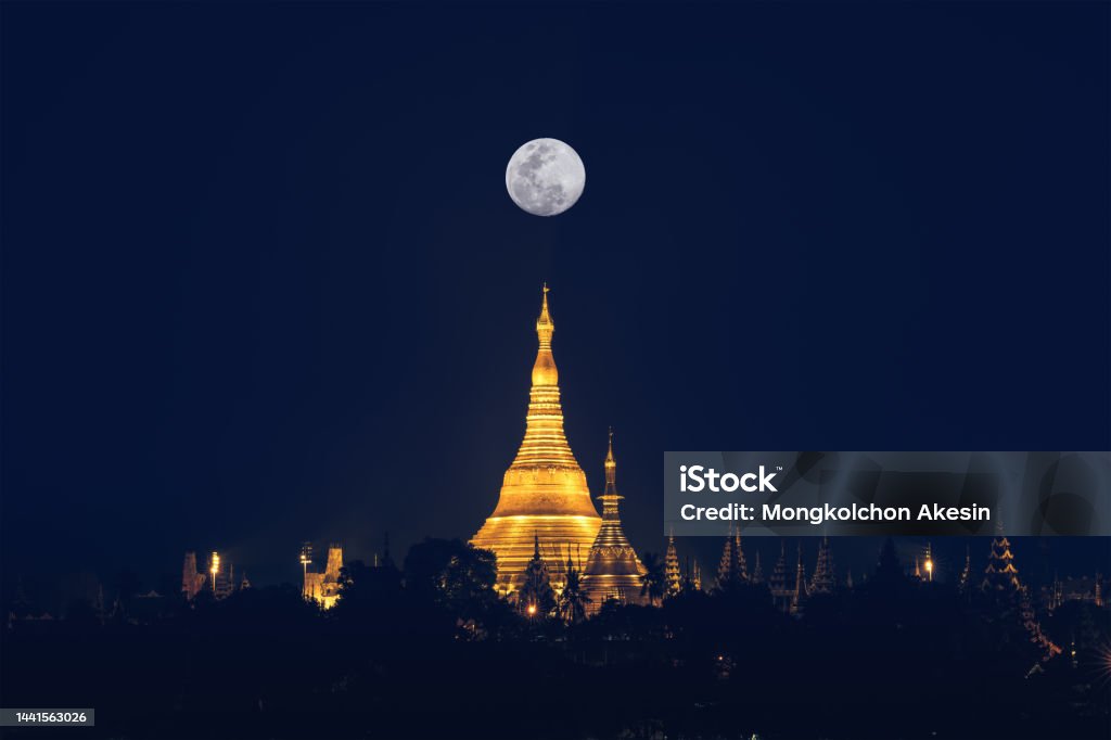 Shwedagon pagoda on hill at fullmoon night famous sacred place and tourist attraction in Yangon Myanmar landscape scenery of Shwedagon pagoda on hill at full moon night famous sacred place and tourist attraction in Yangon Myanmar Ancient Stock Photo