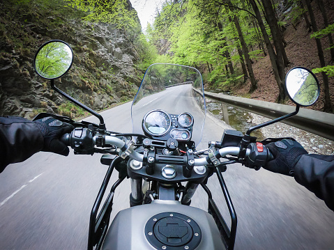 Riding motorcycle through a narrow mountain street very fast