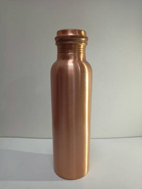 istock Vertical shot of a shiny metallic copper bottleon a white surface 1441566315