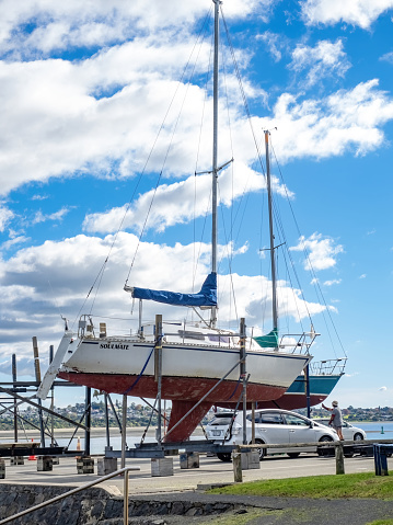 Auckland, New Zealand – May 19, 2021: Yacht on dry dock stand being repaired with antifoul. Auckland, New Zealand - May 13, 2021