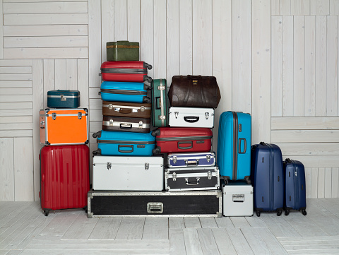 Suitcases multicolor stacked for transport one above the other