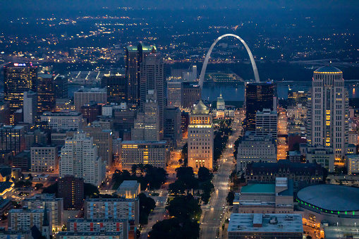 St. Louis, Missouri, USA downtown cityscape with the arch and courthouse at night.