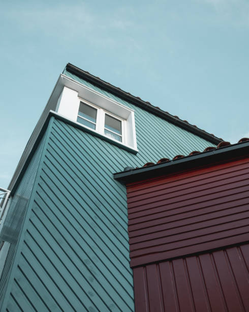 istock Low angle shot of a building with pattern exterior and a white window against a blue sky 1441572498