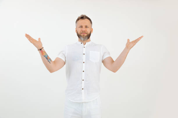 istock Handsome sporty middle-aged bearded man standing, stretching hands, demonstrating on white background. Advertisement. 1441572840
