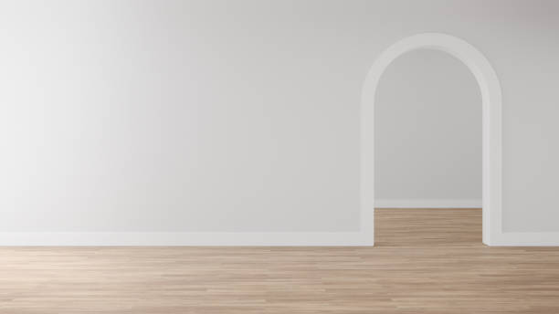 istock Empty grey arch wall with white skirting board on wooden floor 1441574591