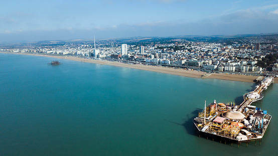 An aerial view of the Brighton West Pier in Brighton, England on blue sky background
