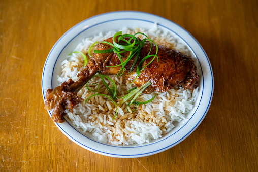 Chicken Adobo with rice, soy sauce and spring onions
