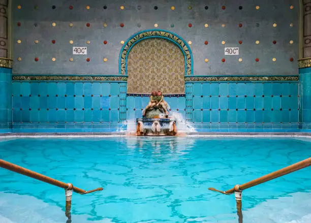 Spectacular design and architecture of Gellert Spa in Budapest, Hungary. Empty therapeutic thermal pool with beautiful blue and turquoise tiles.