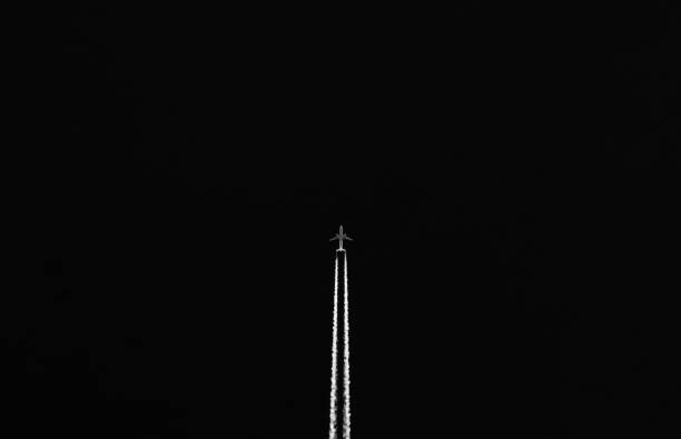 istock Closeup of an airplane flying at night 1441576504
