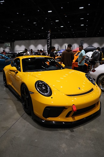 RICHMOND, United States – July 31, 2022: A vertical shot of a yellow Porsche Car in the car show