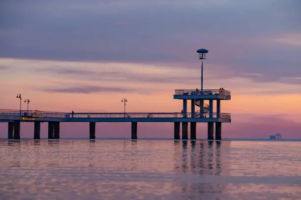 Photo of Stunning view of the famous Burgas sea bridge against a dramatic orange and purple sunset sky