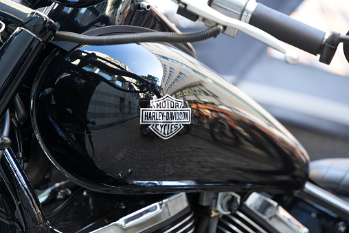 Closeup of tank of parked black Harley Davidson motorcycle on a sunny summer afternoon. Photo taken August 26th, 2022, Winterthur, Switzerland.