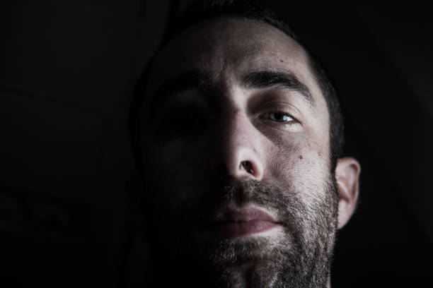 istock Dramatic portrait of a young man half expressionless face in dee 1441577158