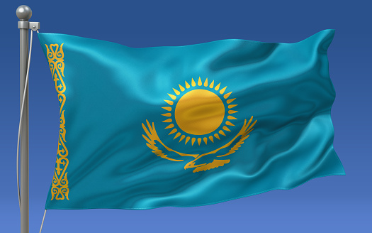 Kazakhstan flag waving on the flagpole on a sky background