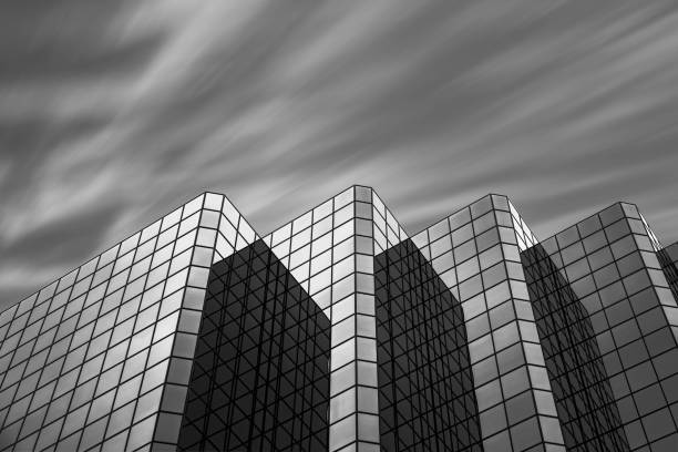 istock Greyscale of a company building with clouds. 1441577535