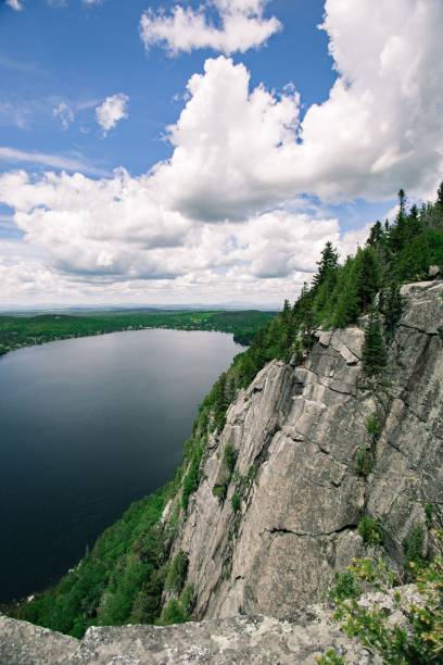 istock Vertical shot of forested mountains and a small lake 1441577654