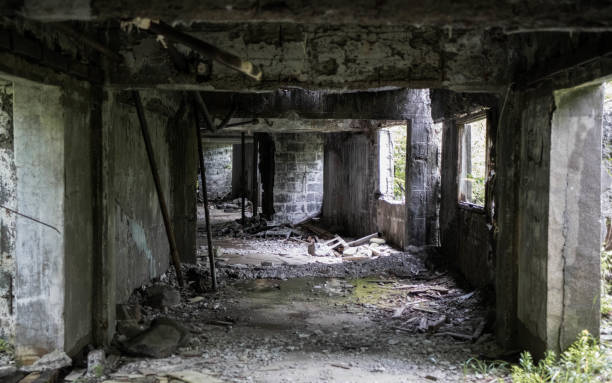 istock Empty and dark hallway with rubbles and concrete walls in an abandoned building 1441577753