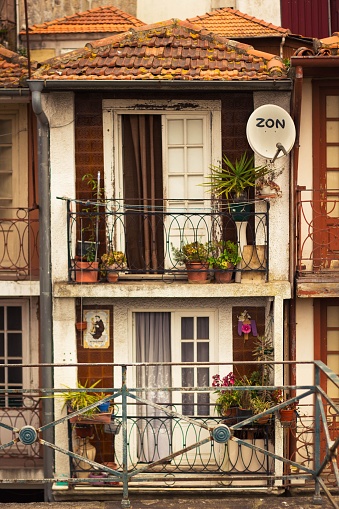 Porto, Portugal – March 28, 2022: A view of beautiful old balconies with plants