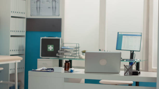 istock Empty office desk with laptop and medical instruments 1441578729