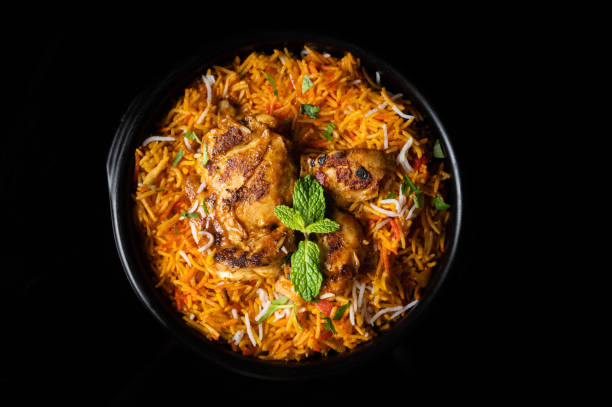 istock Serving of chicken biryani on a black background 1441579286
