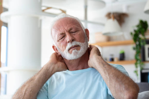 Senior elderly man touching his neck, suffering from neck pain, sciatica, sedentary lifestyle concept. neck health problems. Healthcare, insurance Senior elderly man touching his neck, suffering from neck pain, sciatica, sedentary lifestyle concept. neck health problems. Healthcare, insurance chronic illness stock pictures, royalty-free photos & images