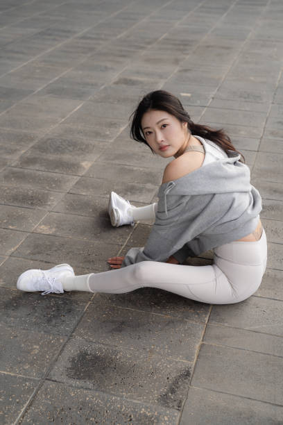 istock Young South Korean female posing while sitting on the ground 1441580228