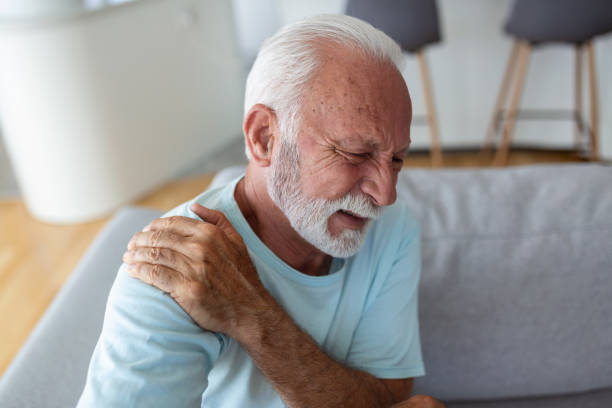 istock Senior elderly man touching his shoulder, suffering from shoulder pain, sciatica, sedentary lifestyle concept. shoulder health problems. Healthcare, insurance 1441580344