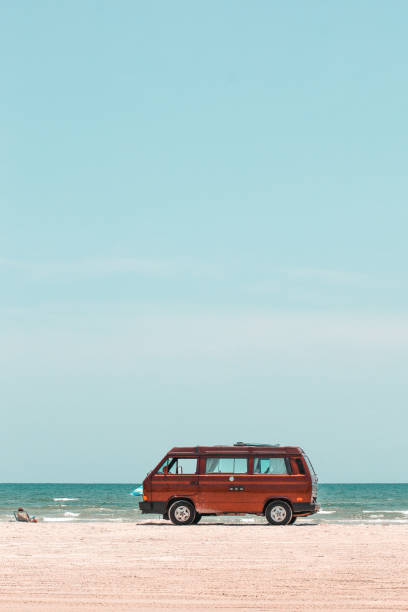 istock Vertical shot of a red travel van on a beach 1441582200