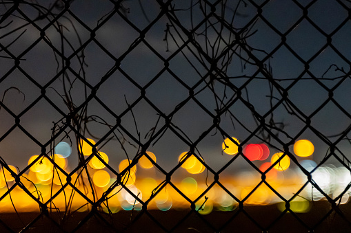 The net fence and bokeh lights on the background
