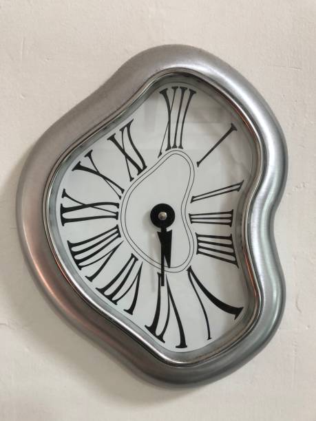 Vertical shot of soft melting clock isolated on white background