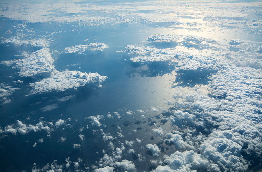 An aerial shot of the sea covered with white clouds