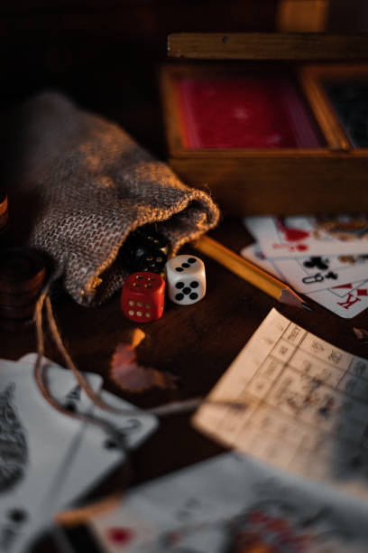 istock Playing cards with game dices and pencil on a table 1441583509