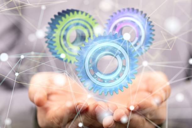 istock Number of gray digital gears floating above two hands in a blurred background - data concept 1441583864